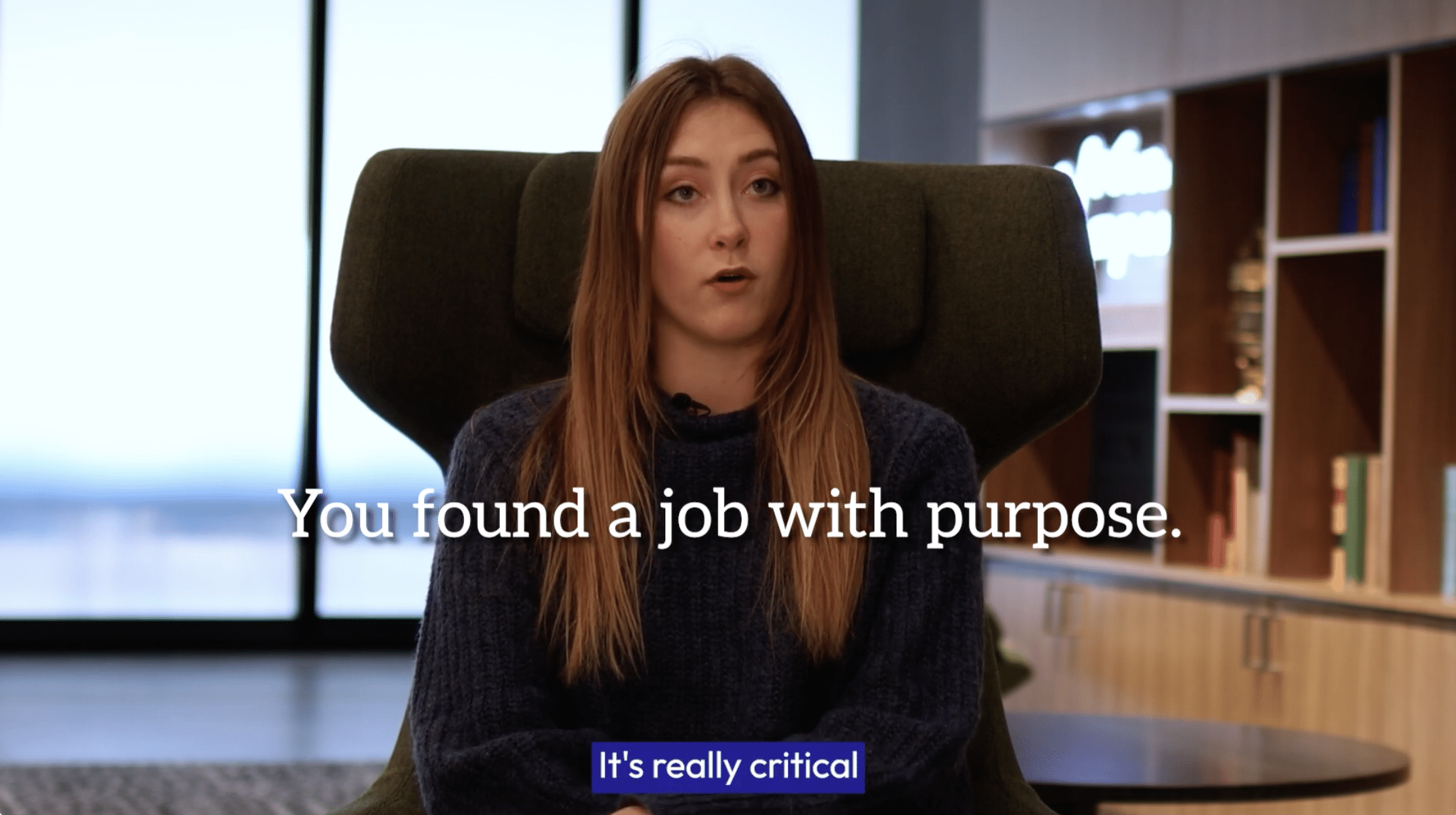 Young woman sitting in the lobby of a building talking about her experience working in insurance